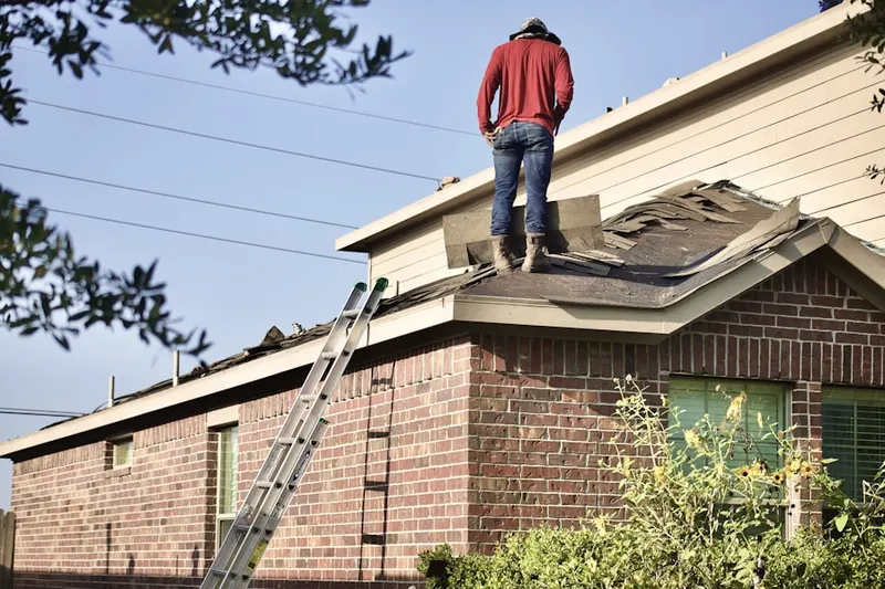 Professional roofer working on a residential roof in Chesapeake Terrace
